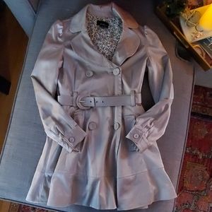Silver A-line trench coat with belt.